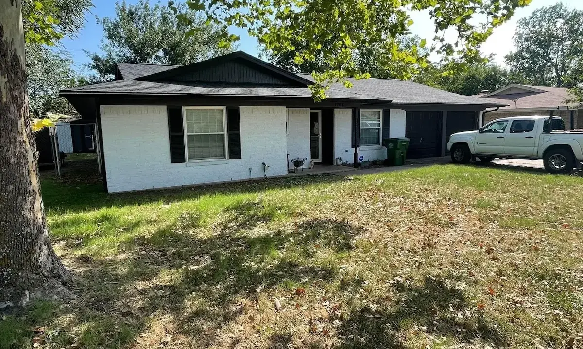 Professional roofing crew working on a residential roof in Bedford